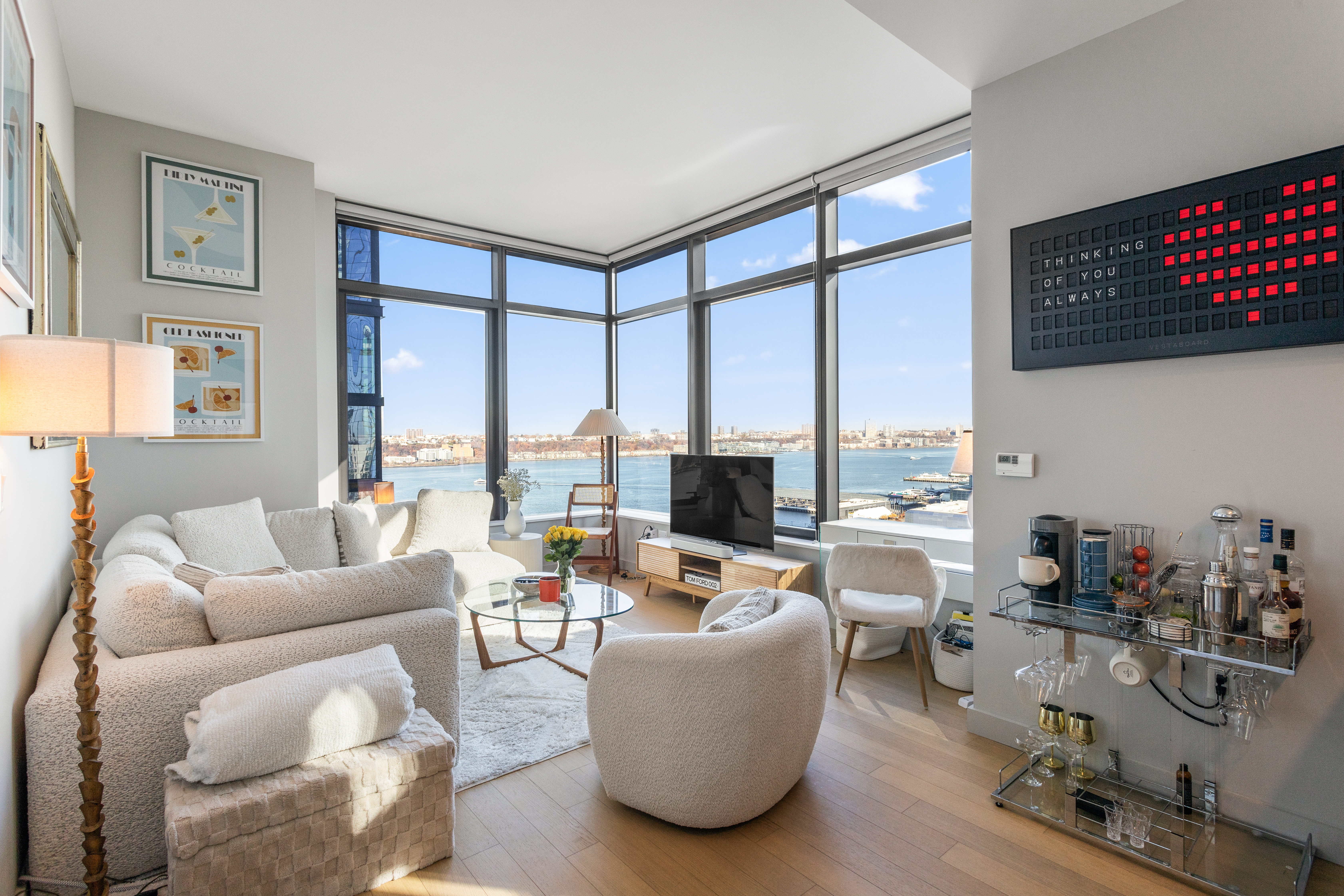 a living room with furniture and a floor to ceiling window