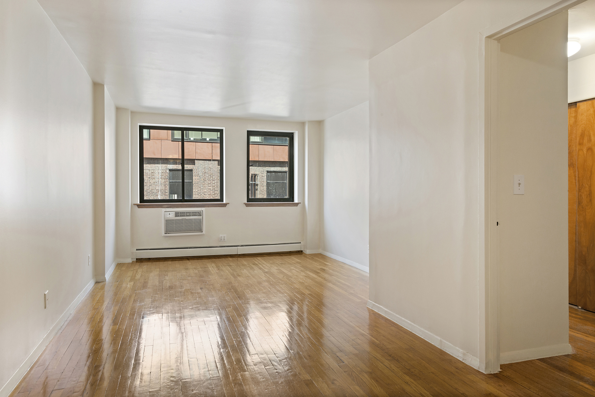 a view of wooden floor and windows in a room