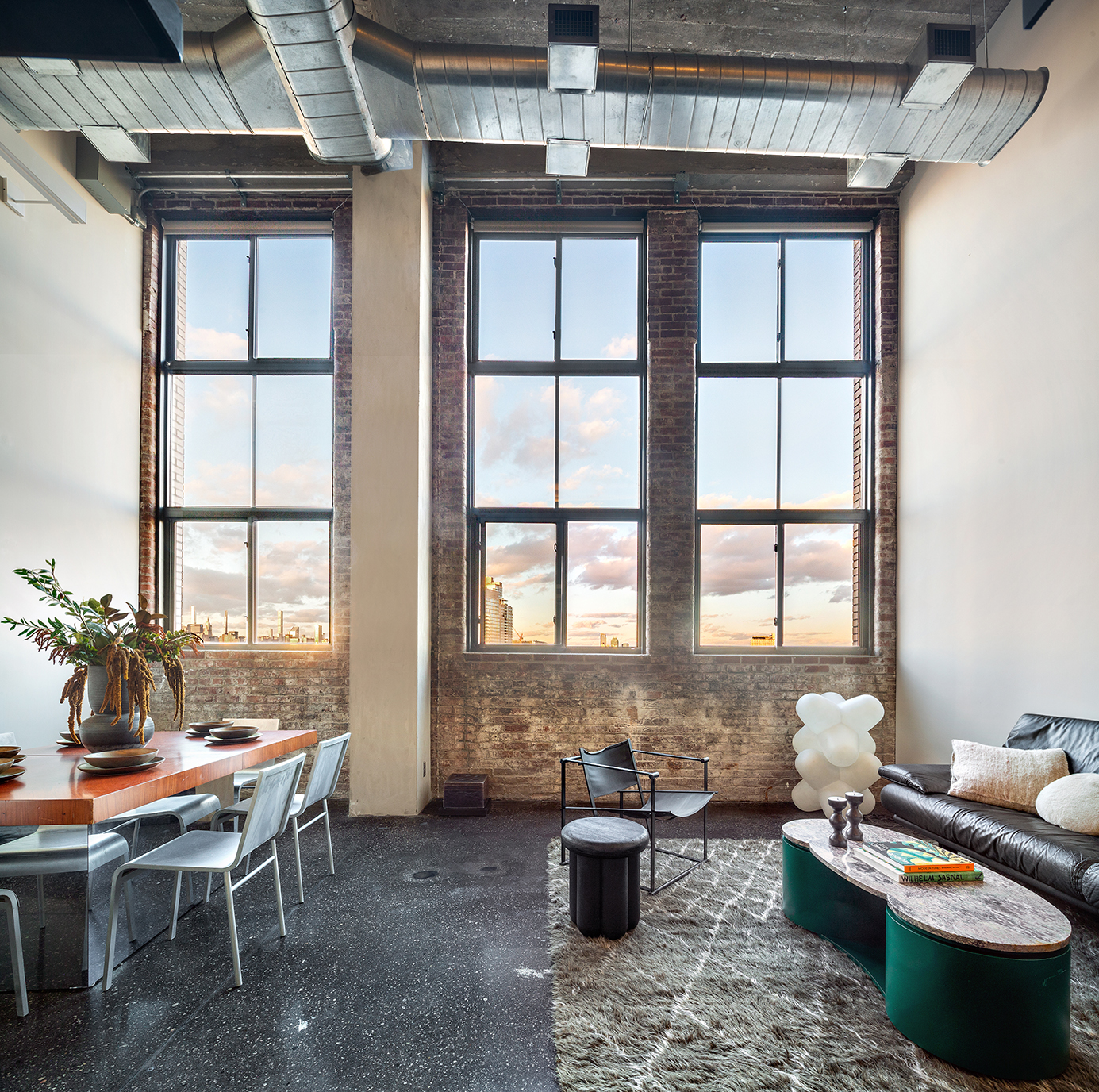 a living room with furniture and floor to ceiling window