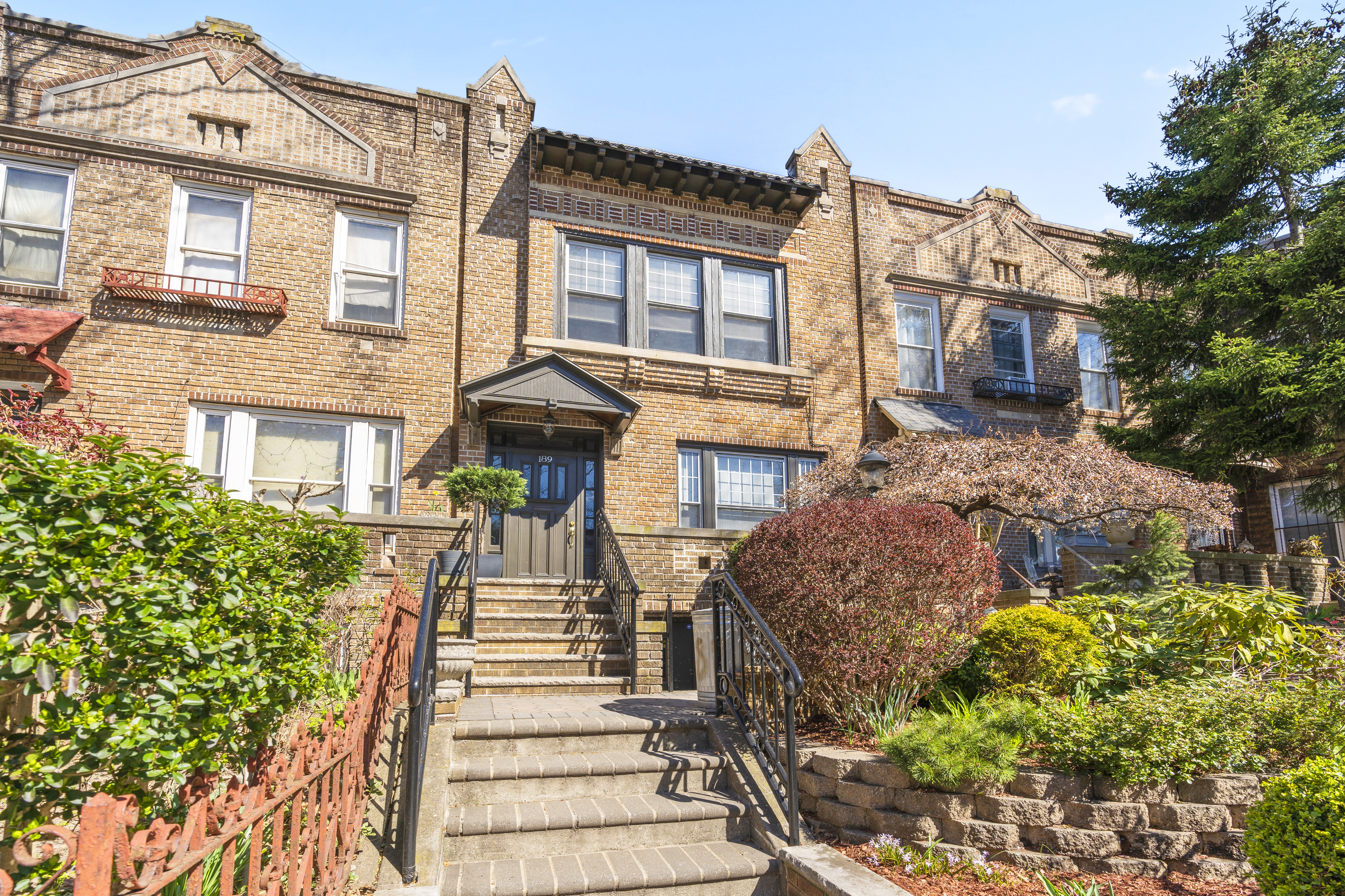 a front view of a residential apartment building with a yard