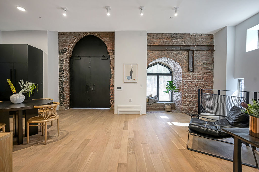 a view of living room with furniture and wooden floor