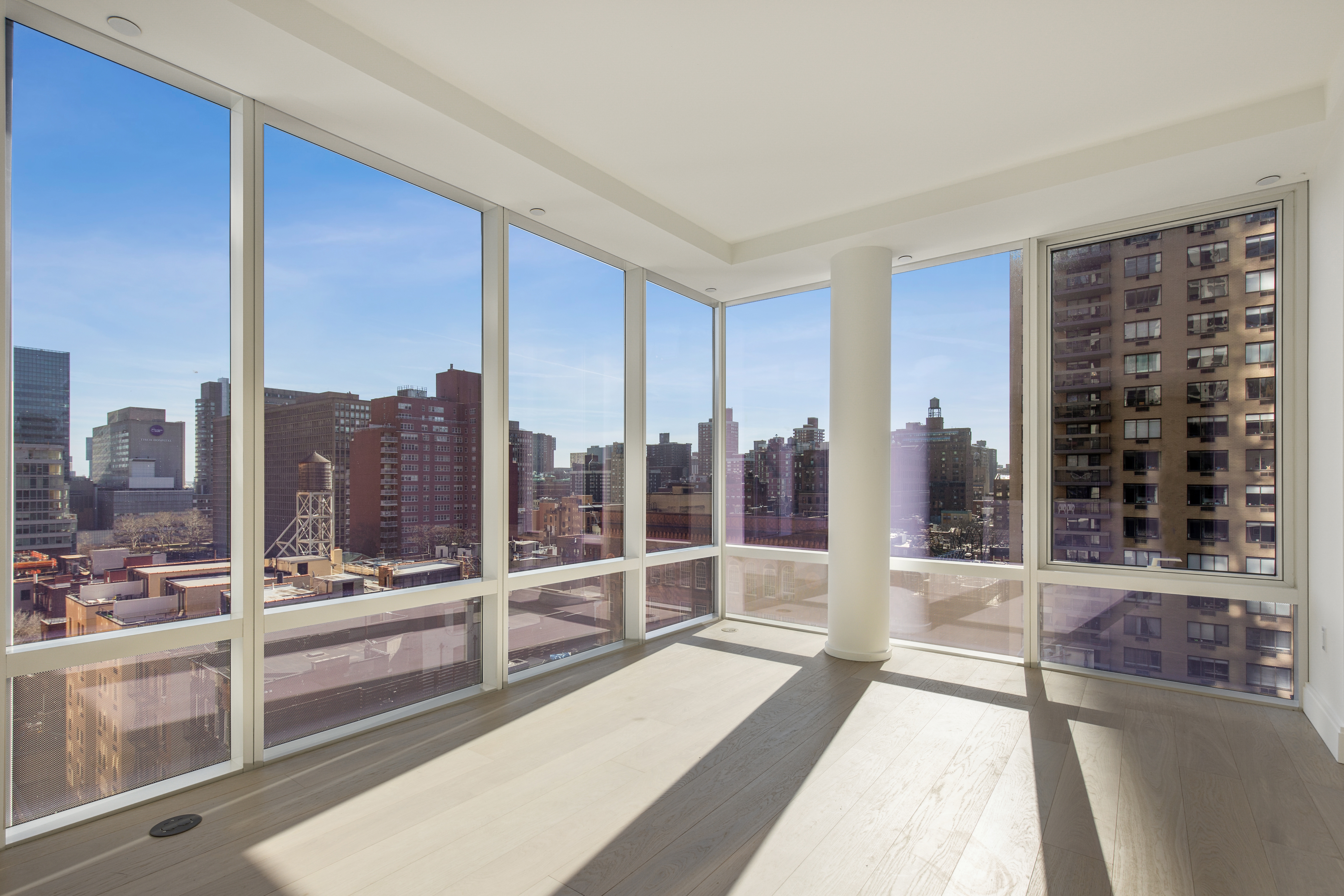 a view of a living room with a large window and city view