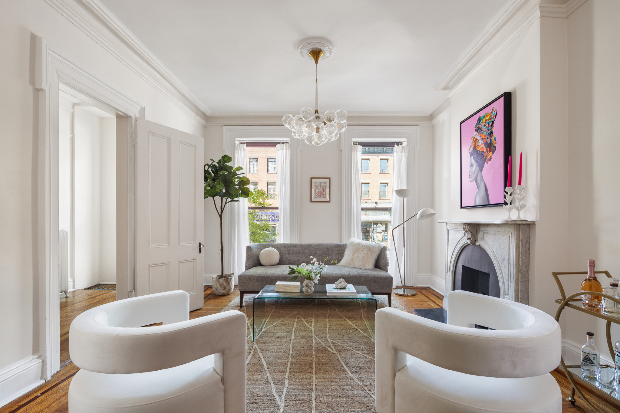 a living room with furniture a fireplace and a chandelier