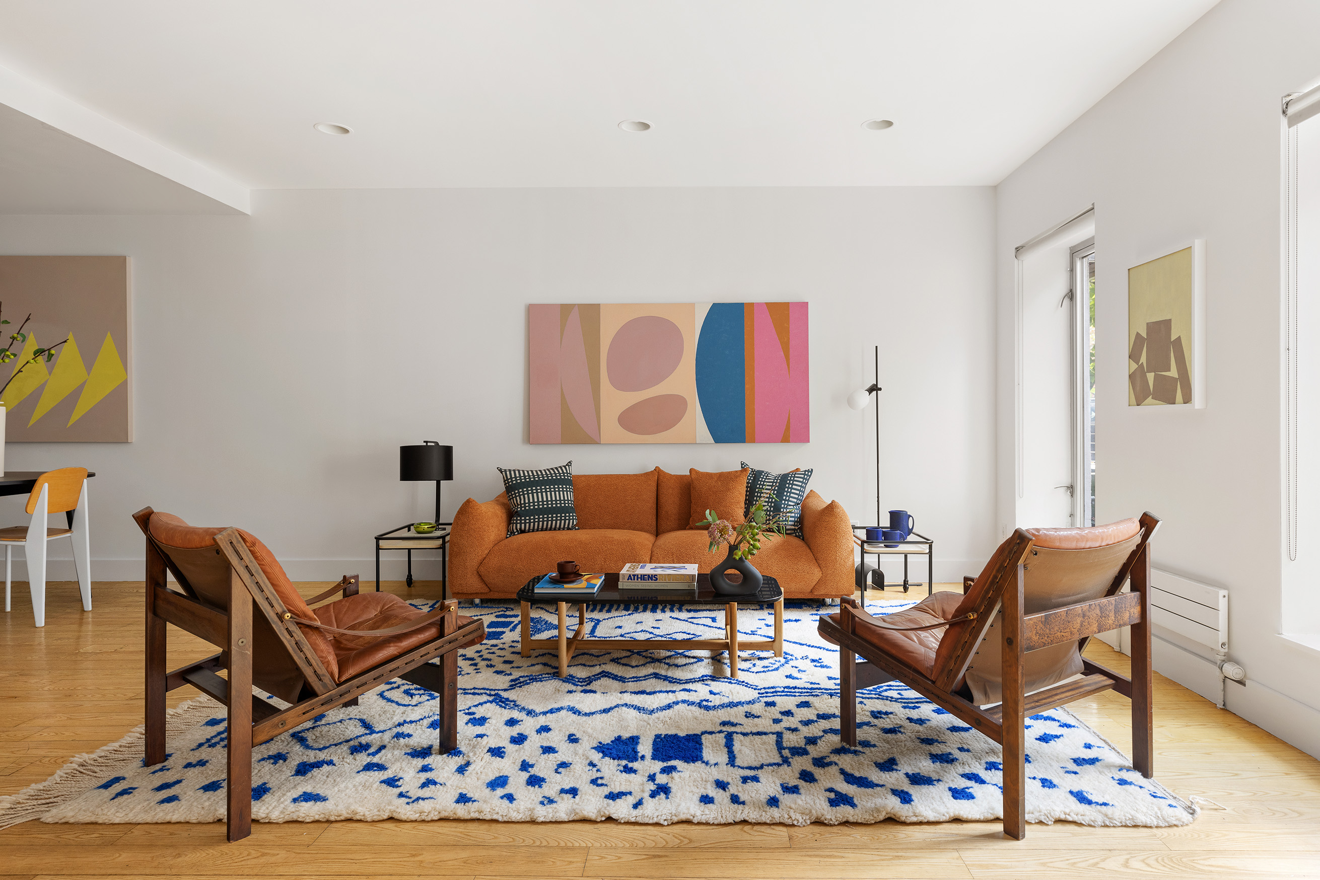 a living room with a couch and a rug