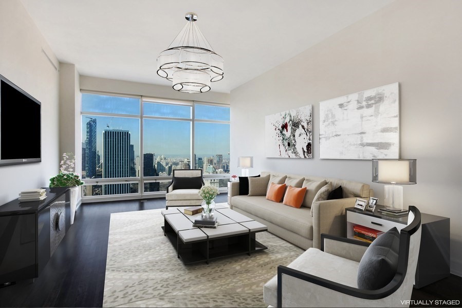 a living room with furniture kitchen view and a flat screen tv