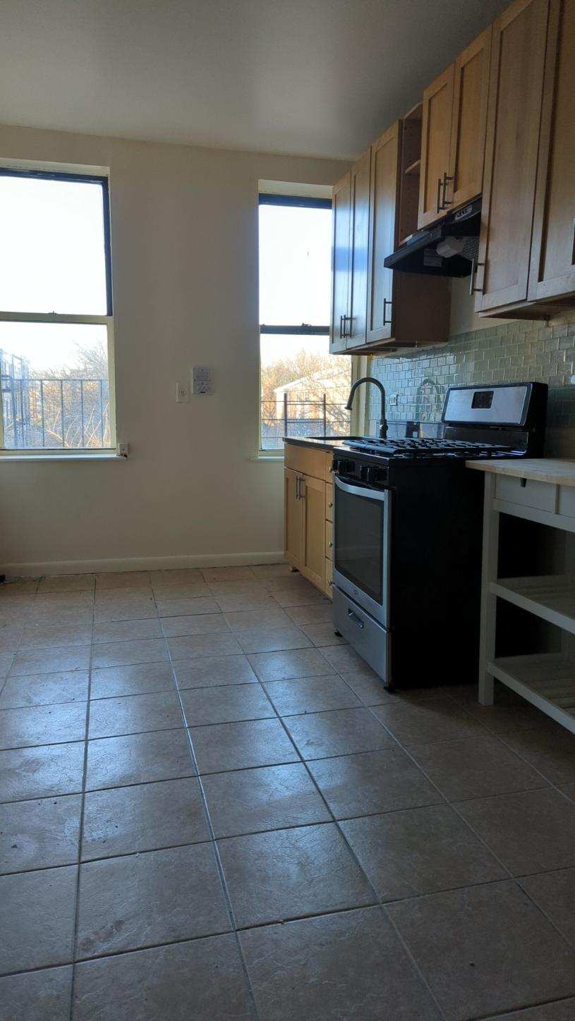 a kitchen with a sink a stove a microwave and cabinets