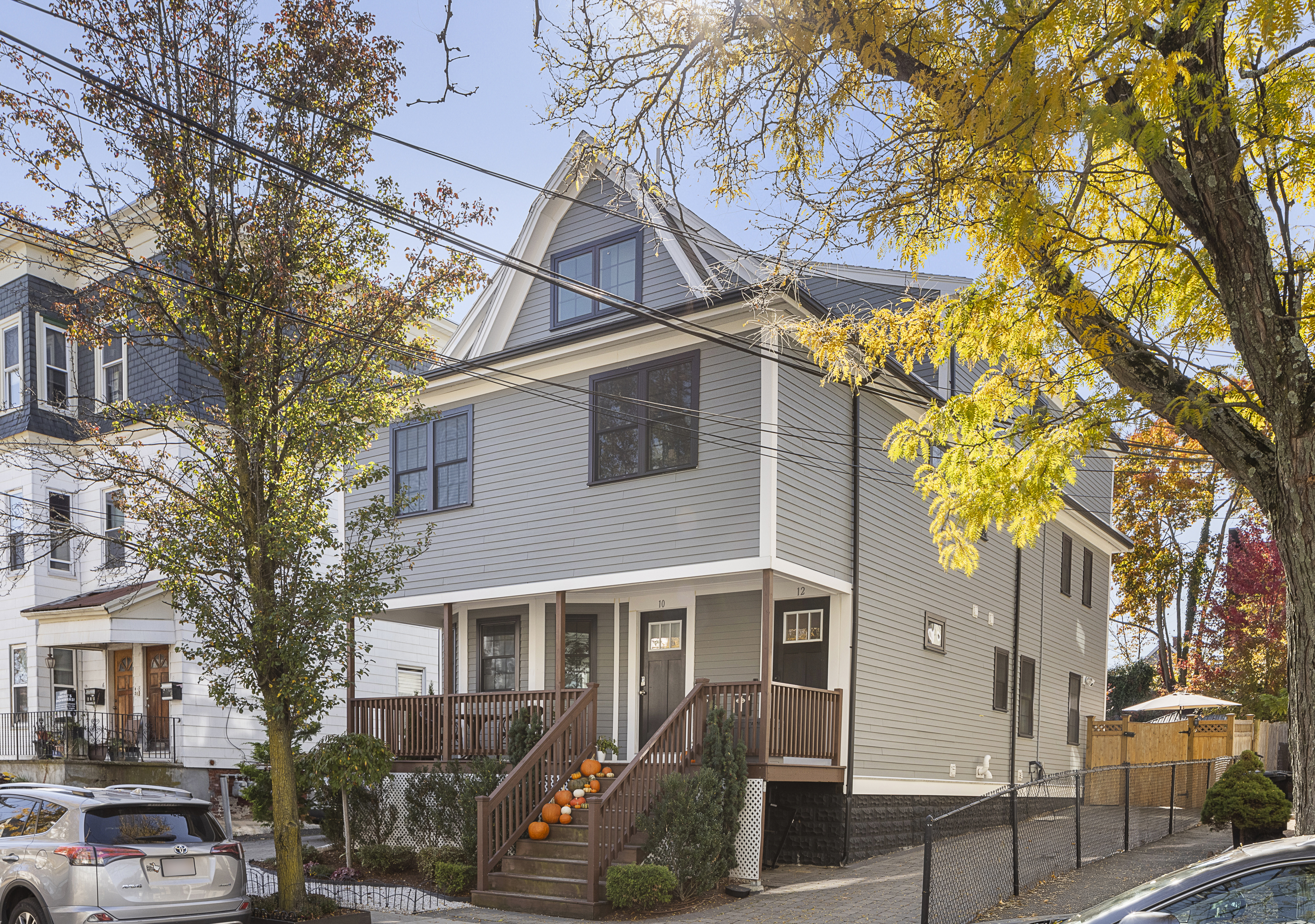 a front view of a house with a tree