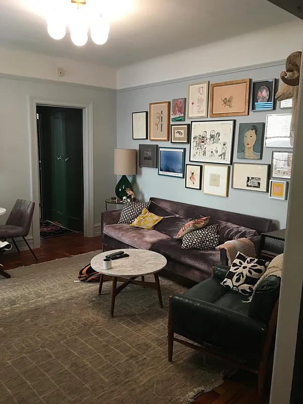 a living room with furniture lamp and rug