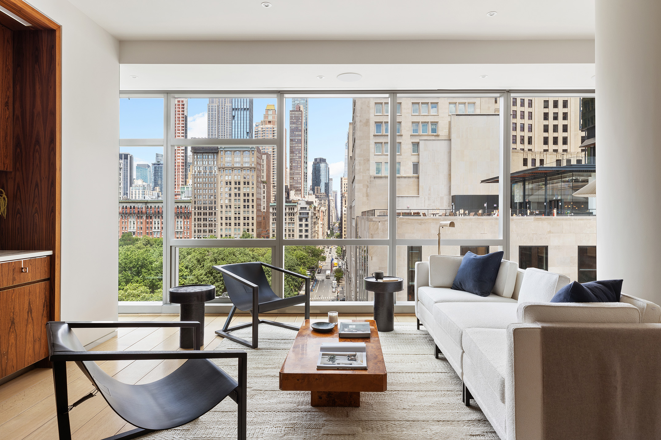 a living room with furniture and a floor to ceiling window