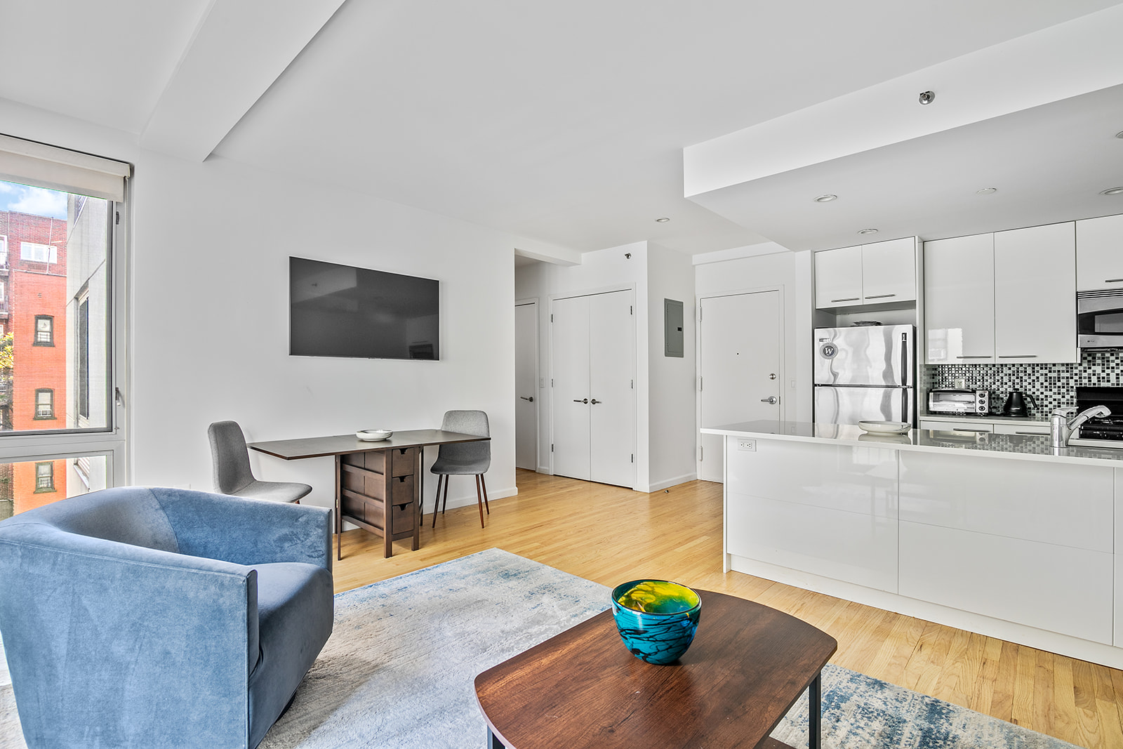 a living room with furniture wooden floor and a flat screen tv