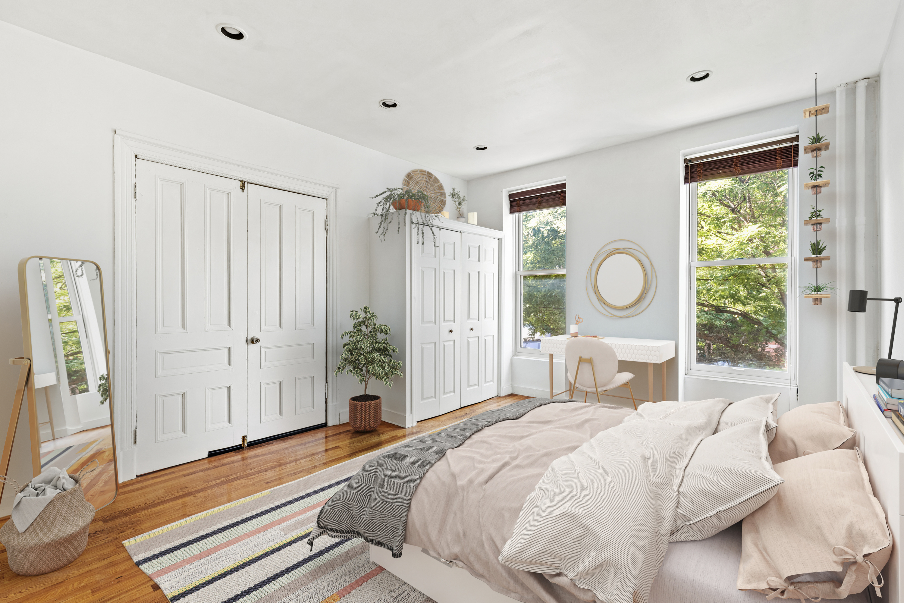 a bedroom with a large bed and wooden floor