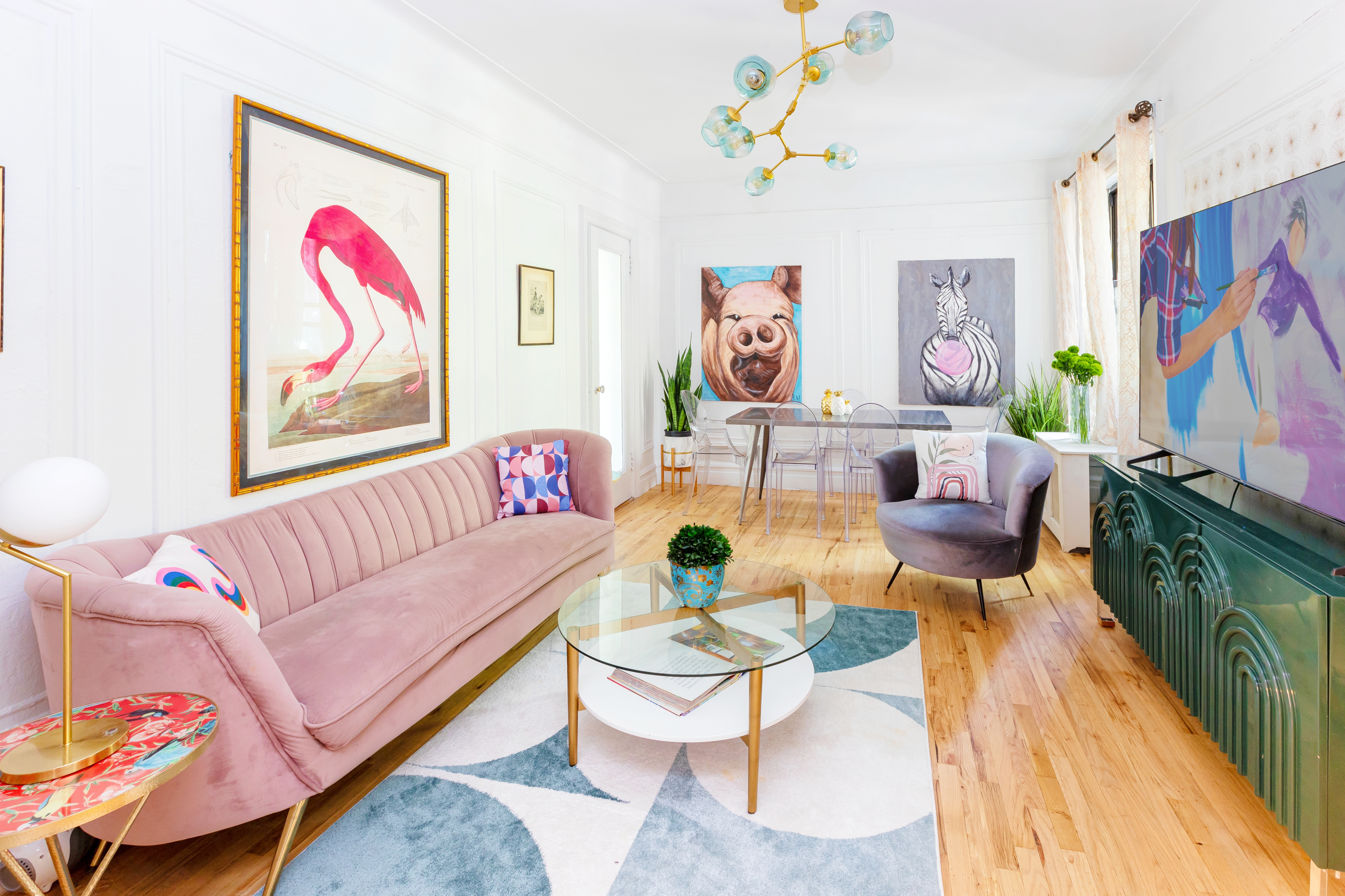 a living room with furniture and a wall painting