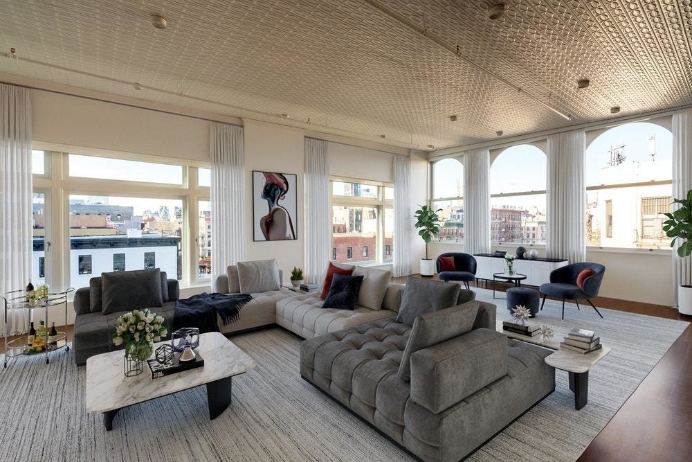 a living room with furniture large window and wooden floor