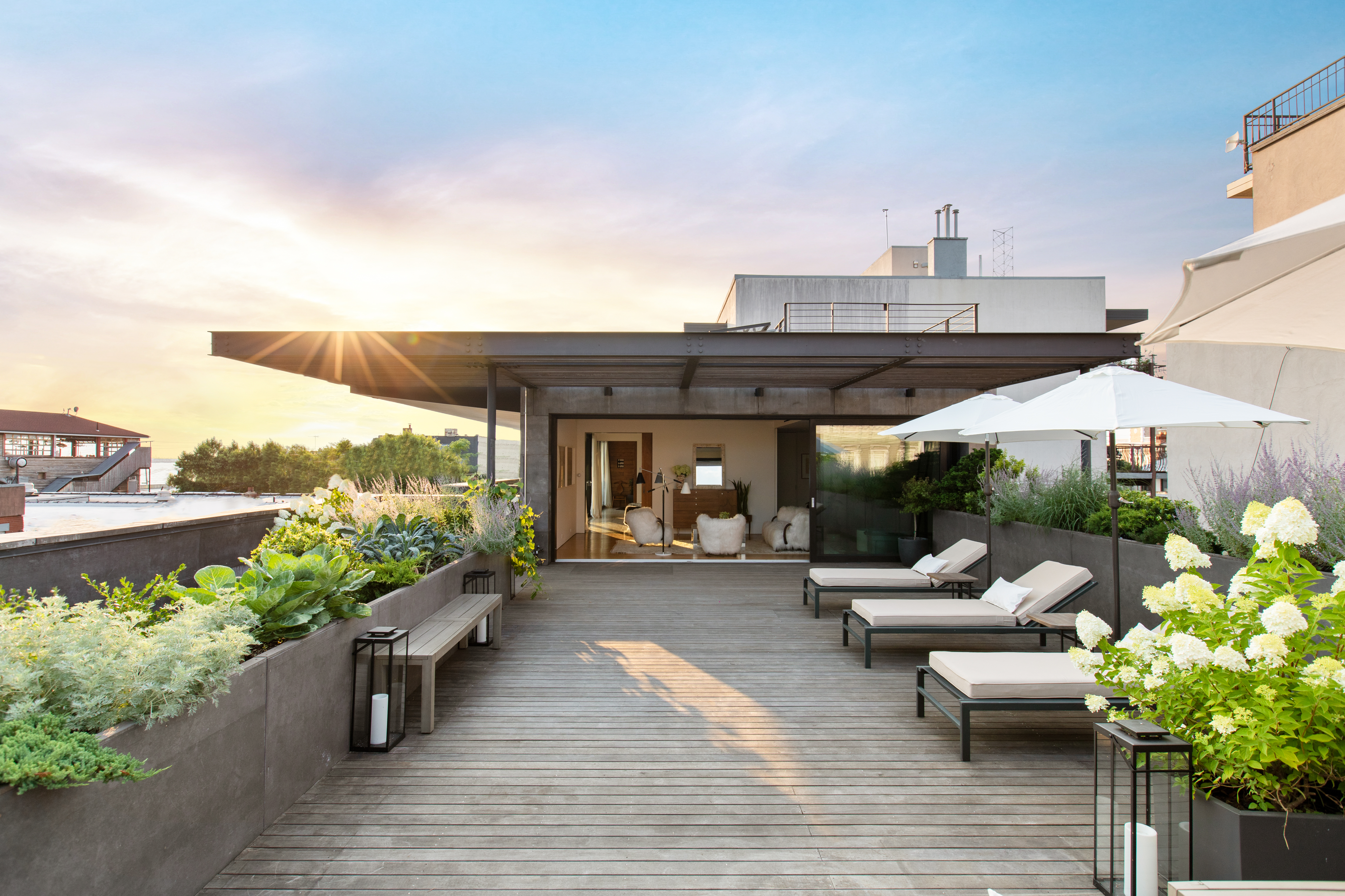 a view of a patio with couches table and chairs and potted plants