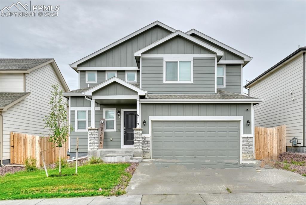 a front view of a house with a yard and garage