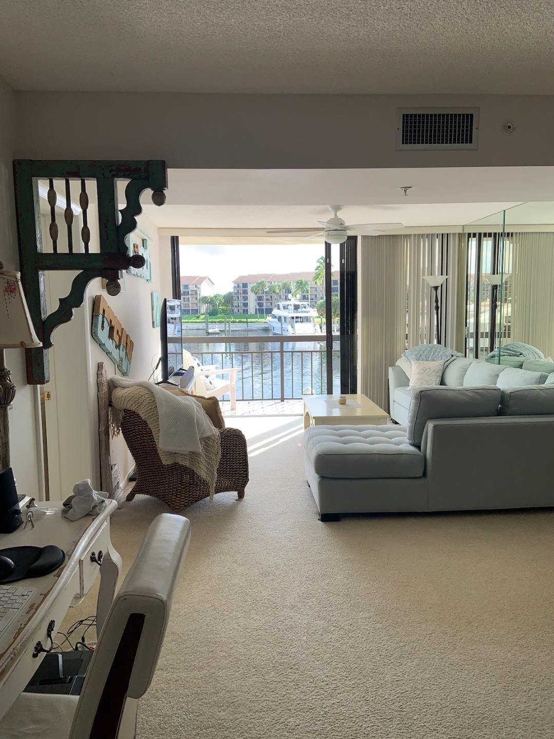 a living room with furniture and a floor to ceiling window