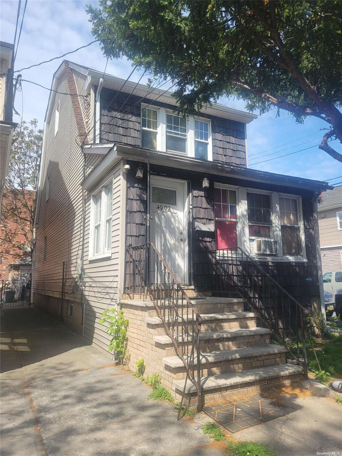 a front view of a house with parking