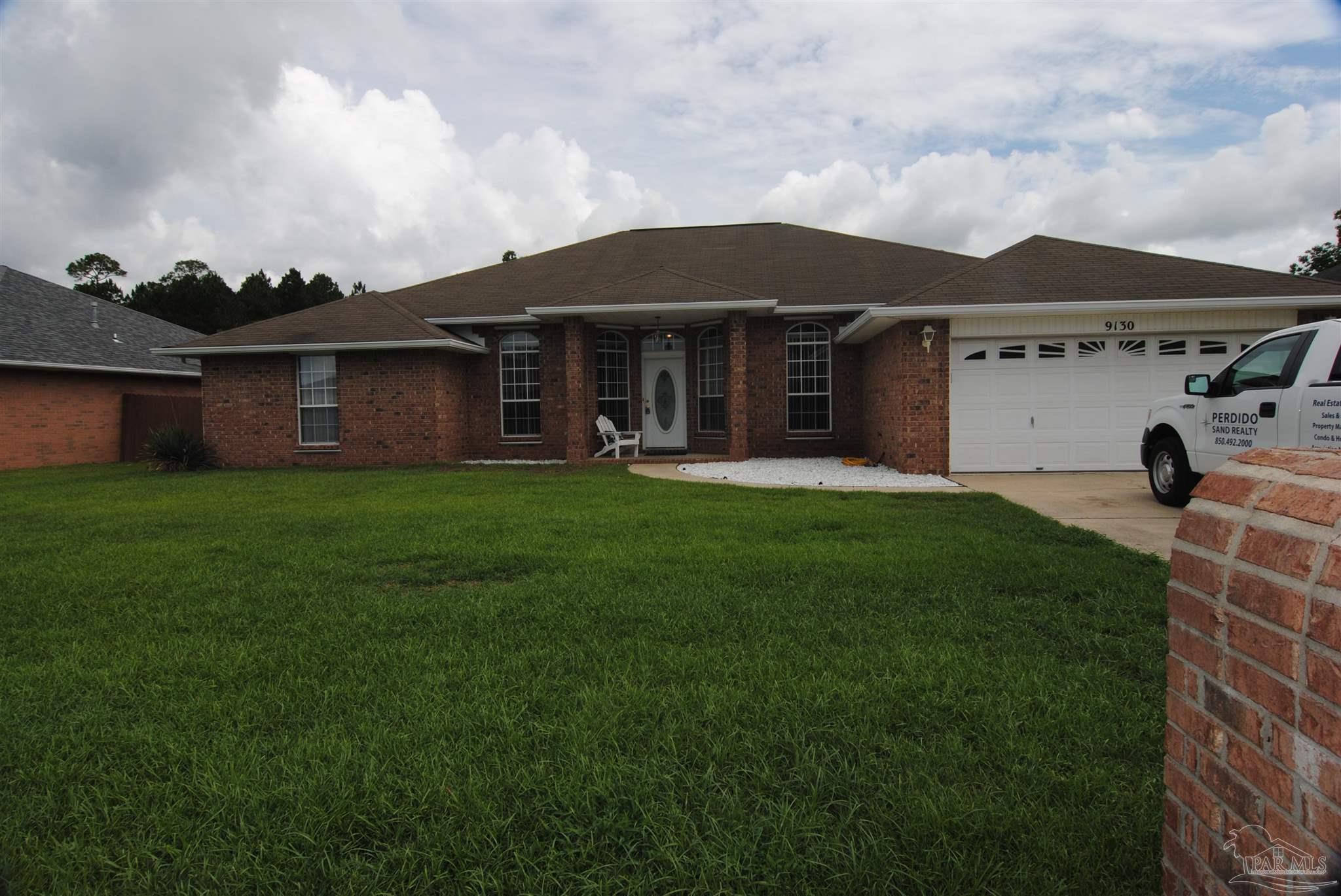 a view of a house with a garden and yard