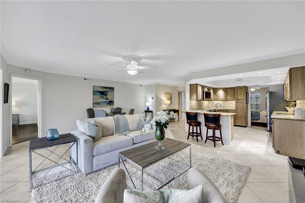 a living room with furniture and view of kitchen