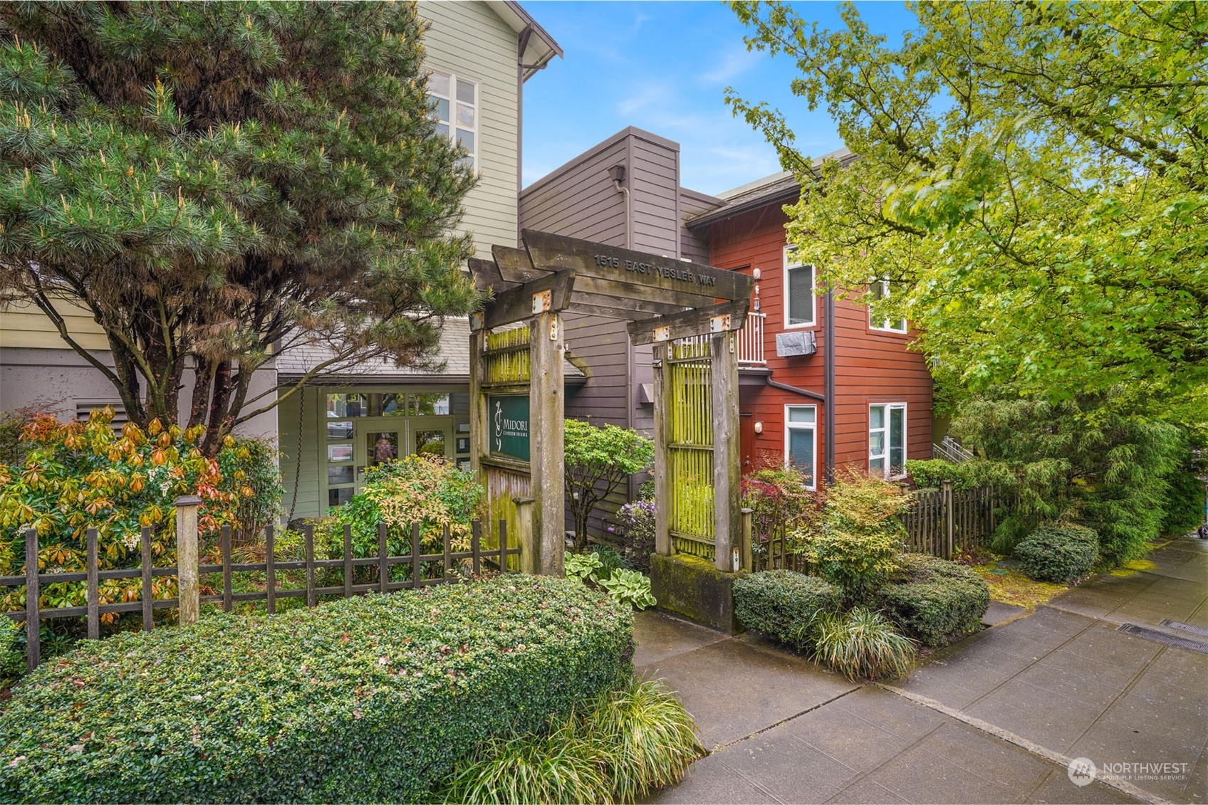 a view of a house with brick walls and flower plants