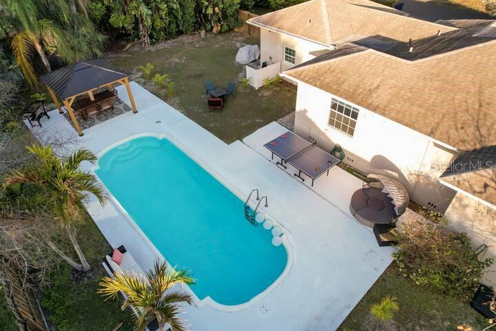 an aerial view of a house with a swimming pool