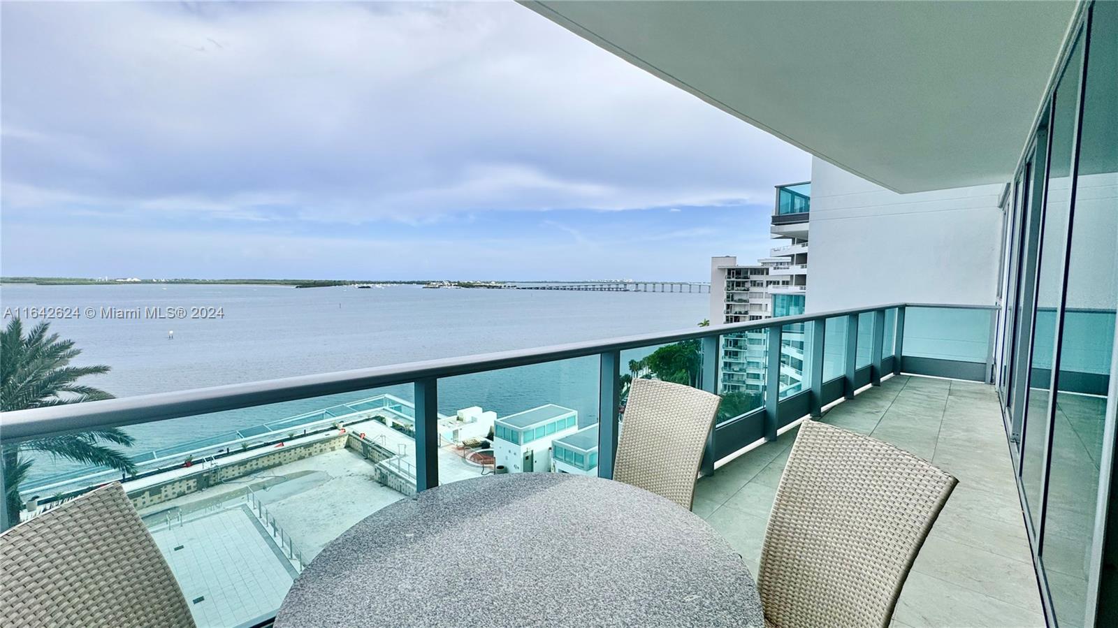 a balcony with furniture and a potted plant