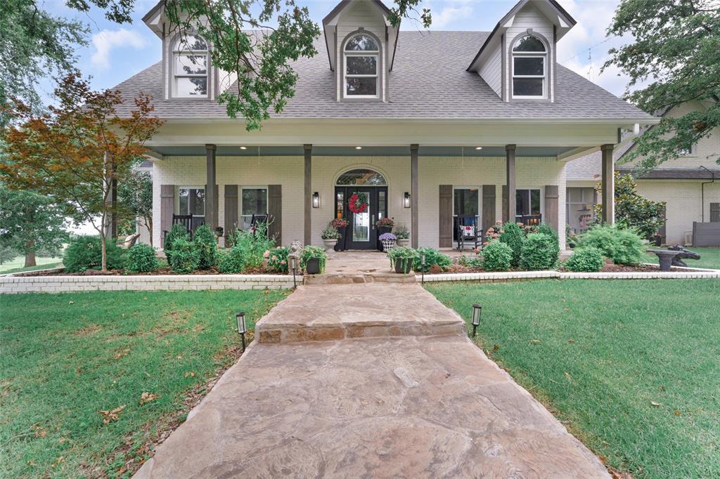 front view of a brick house with a yard