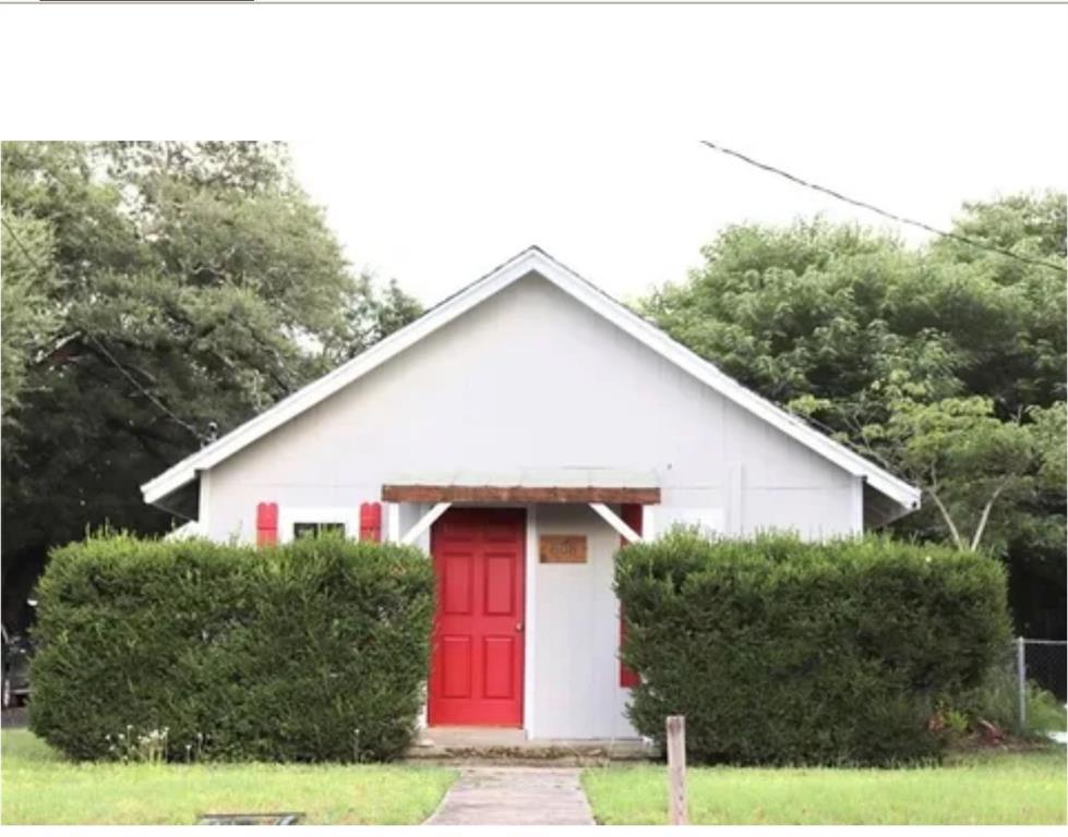 a aerial view of a house next to a yard