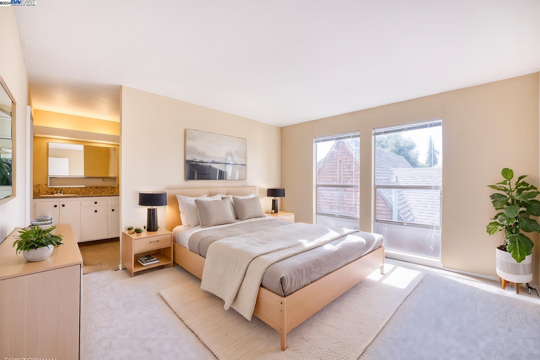 a bedroom with a large bed and a potted plant