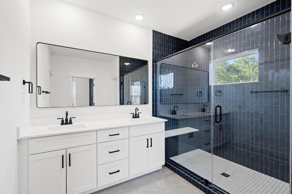 a bathroom with a double vanity sink mirror and toilet