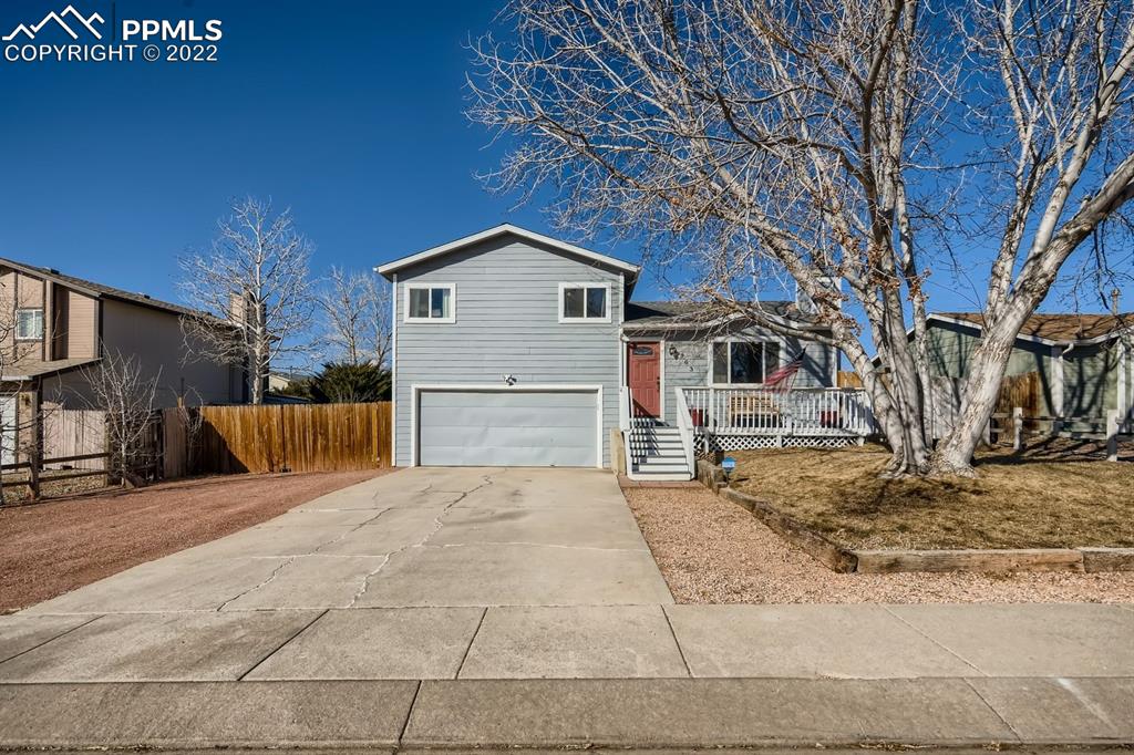 a view of a house with a yard covered in snow