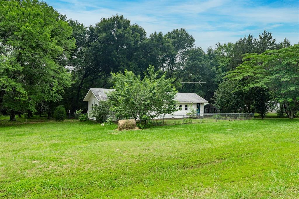 a view of a garden with a house in the background