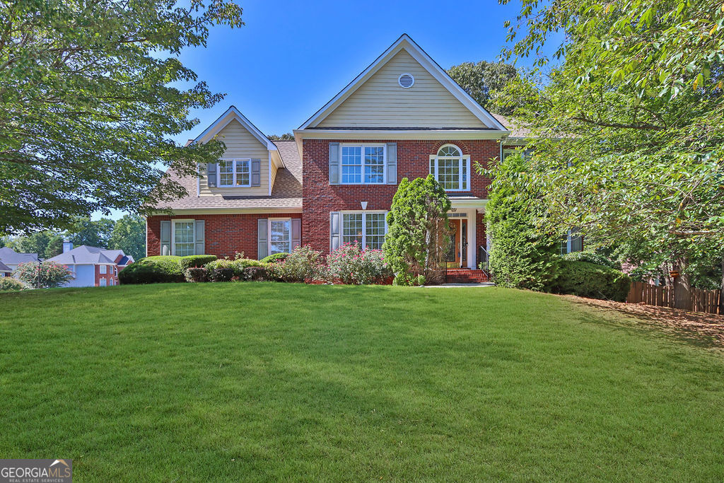 a front view of a house with a garden