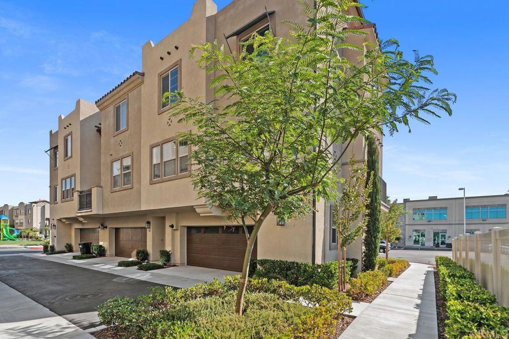 a front view of a multi story building with yard