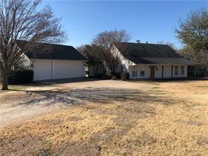 a view of a house with a yard and a large tree