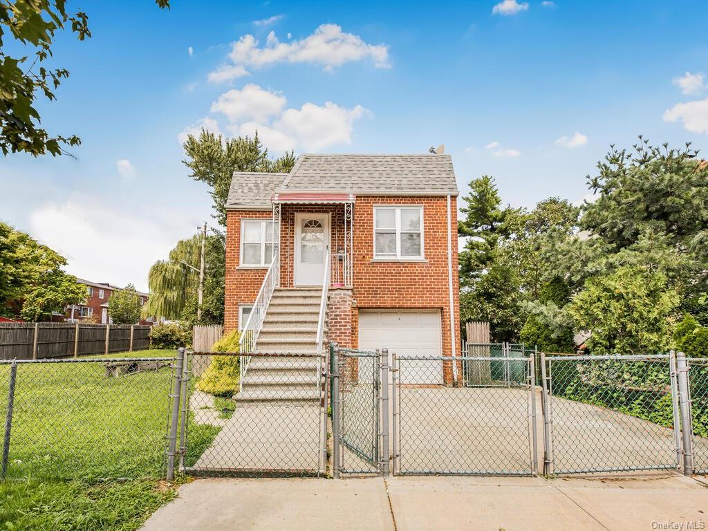 View of front facade with a front yard and a garage