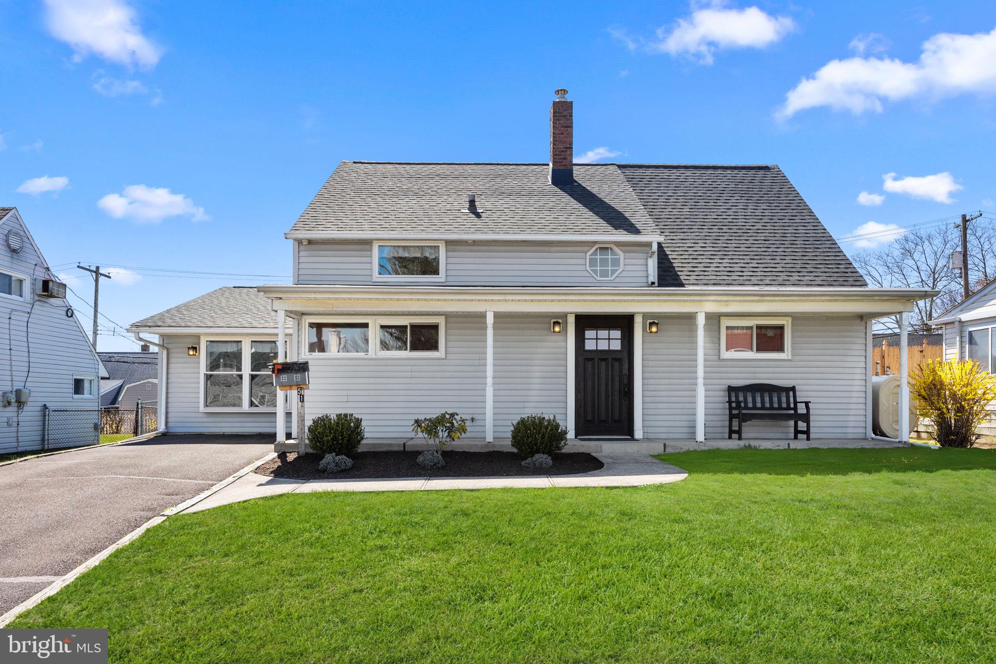 a front view of a house with a garden and yard