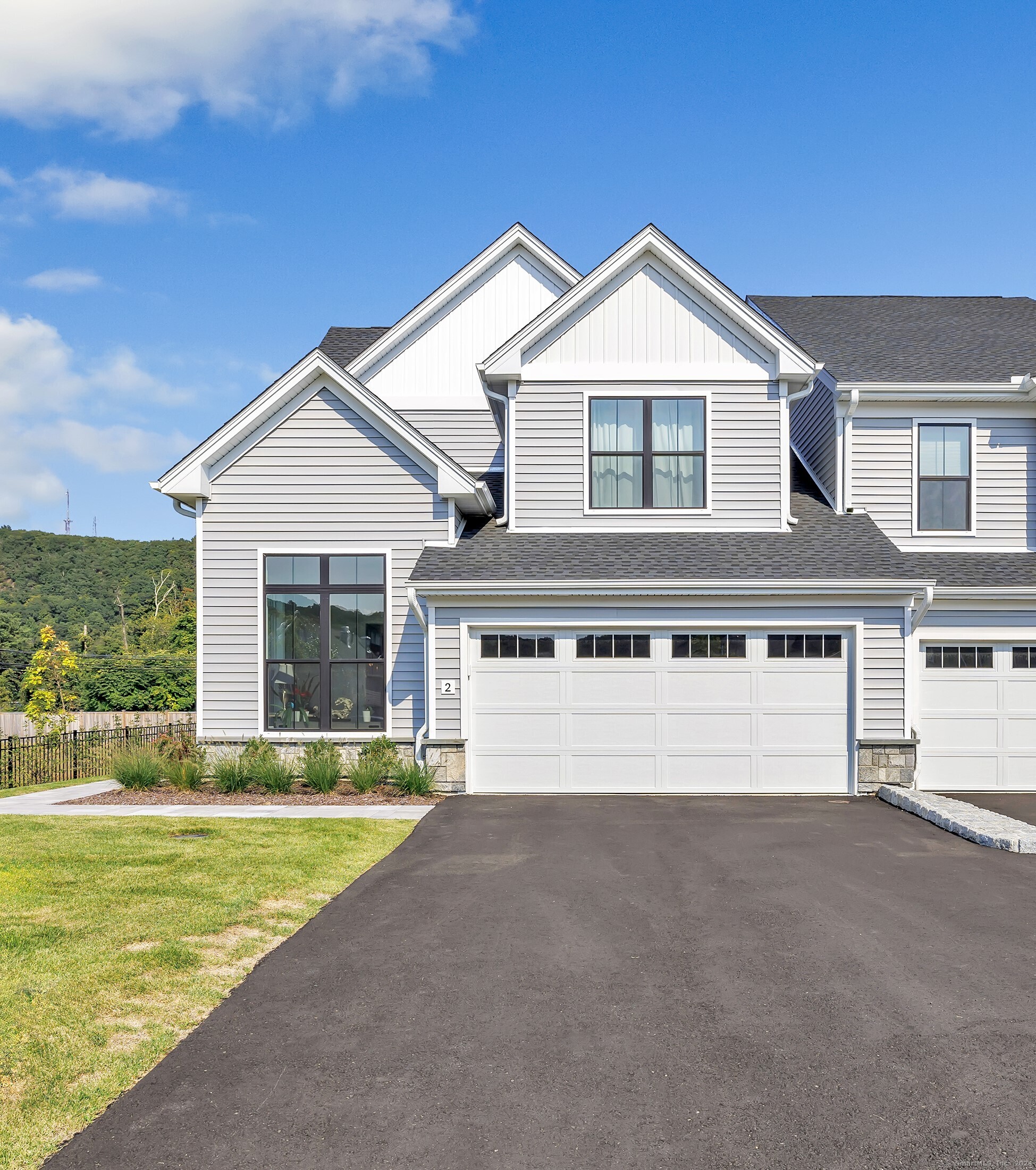 a view of house with outdoor space and parking