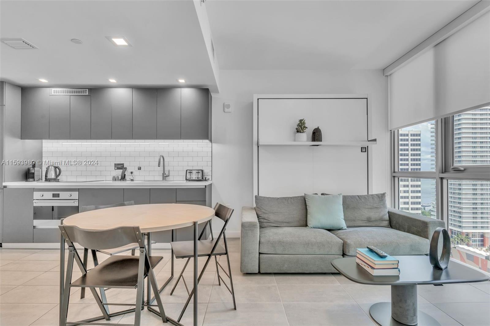 a living room with furniture and kitchen view