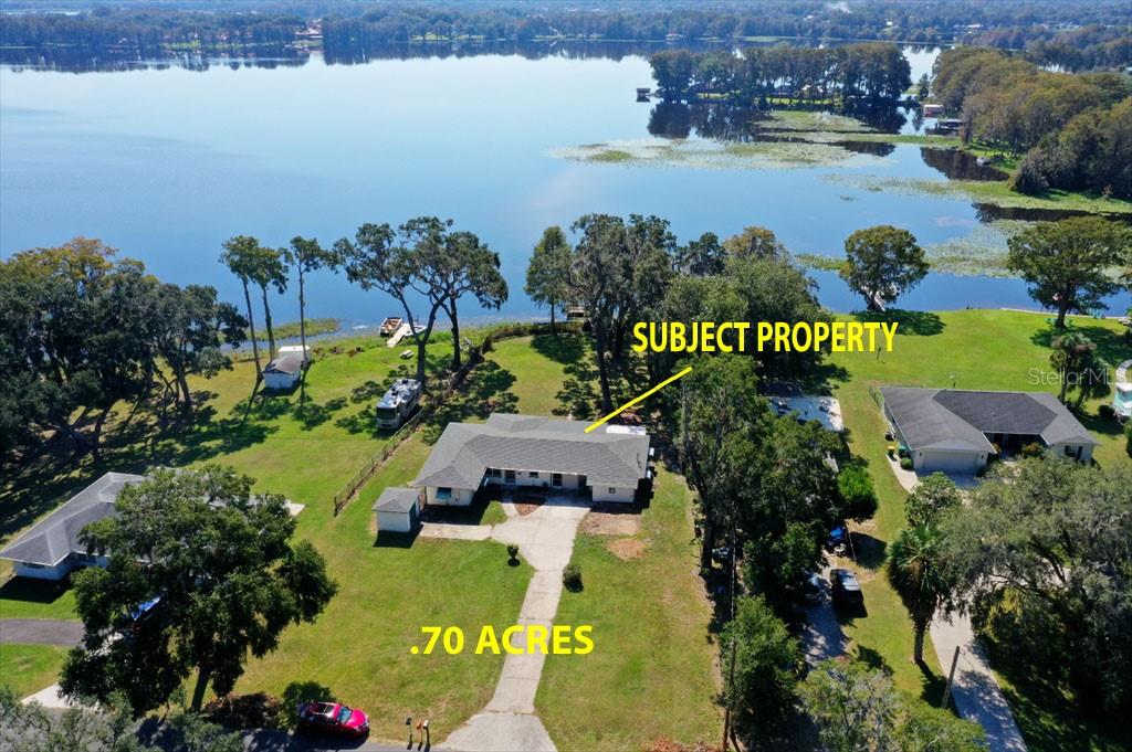 an aerial view of a houses with a lake view