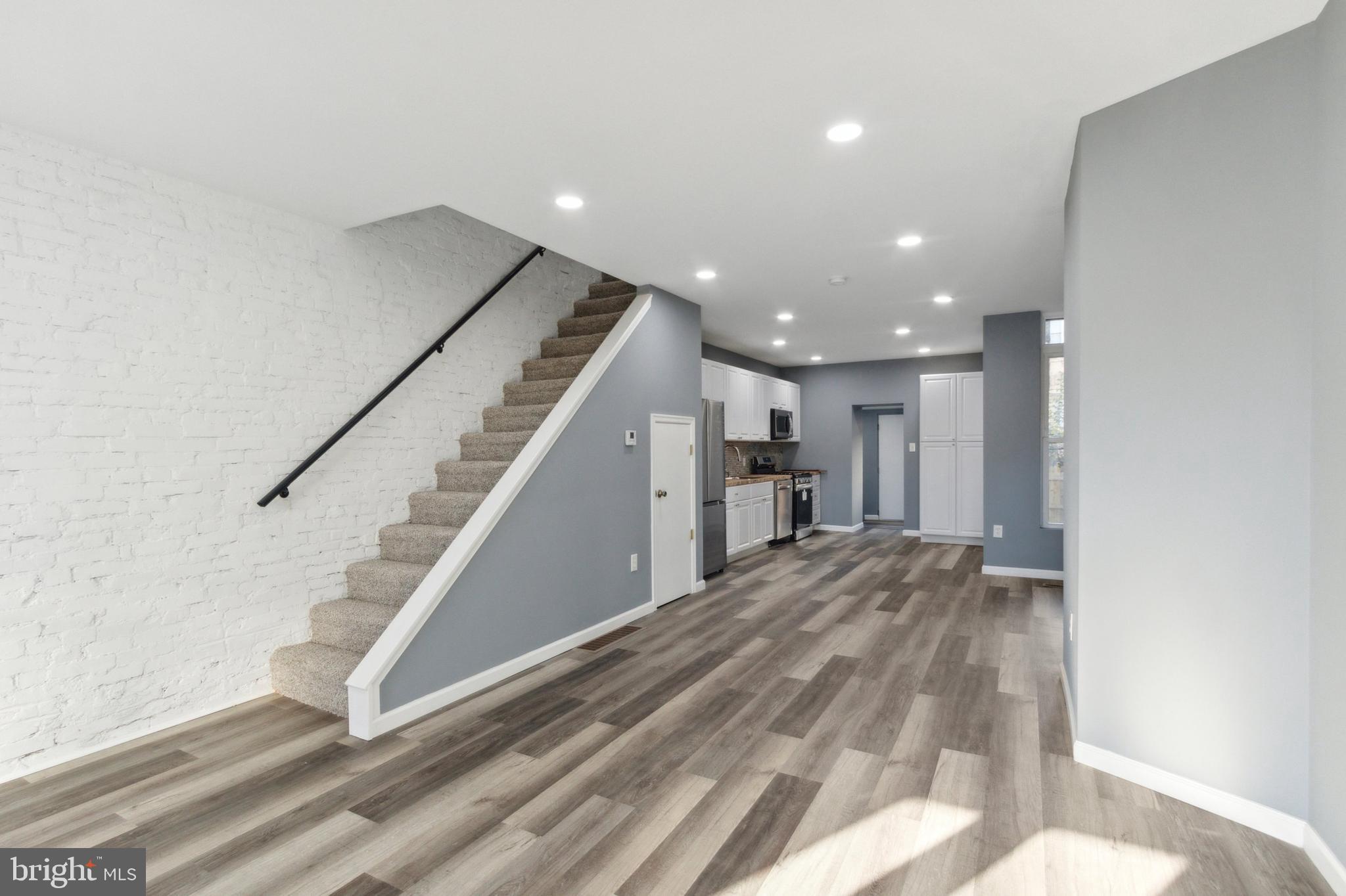 a view of entryway and hall with wooden floor