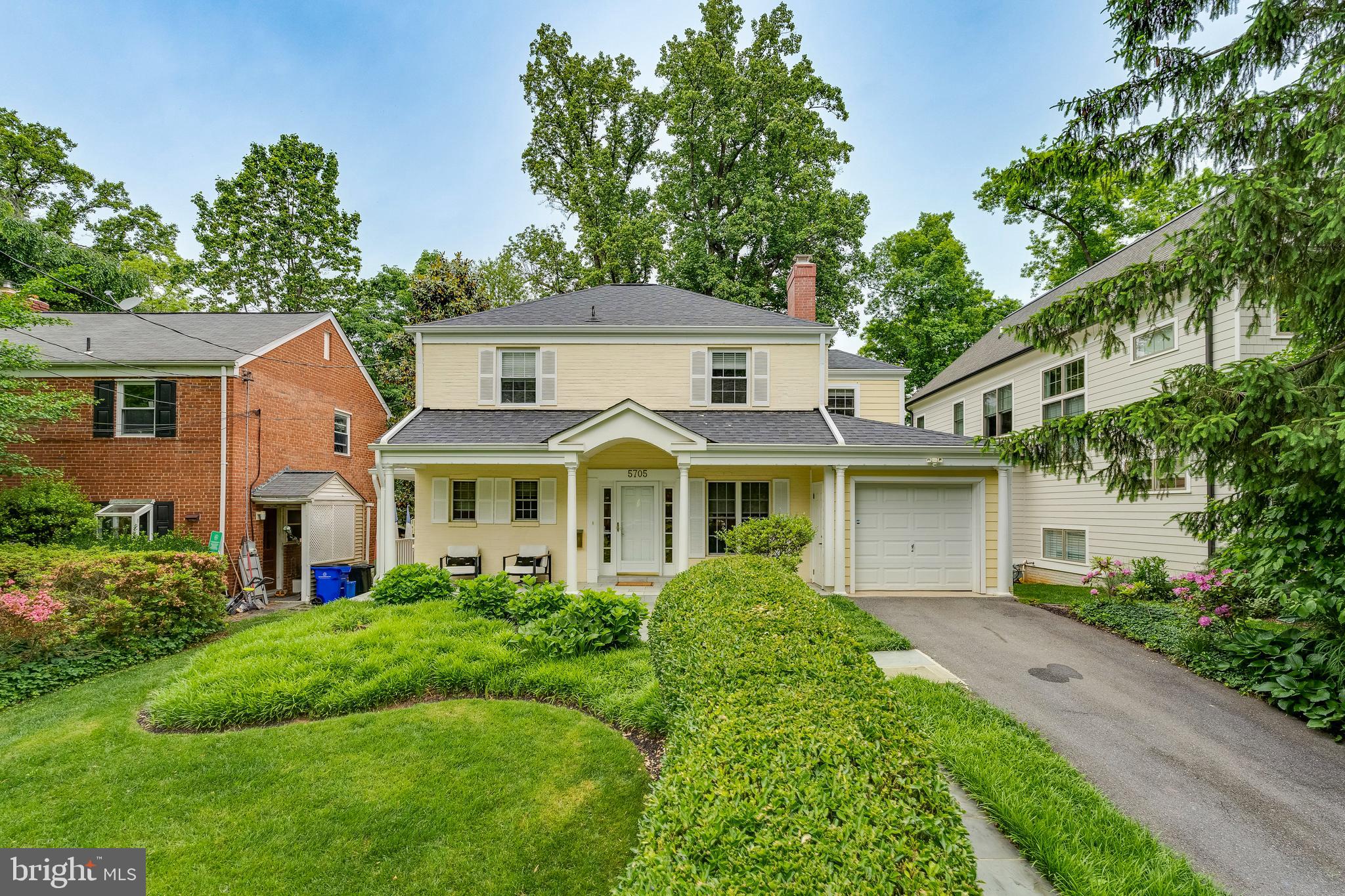 a front view of house with yard and green space