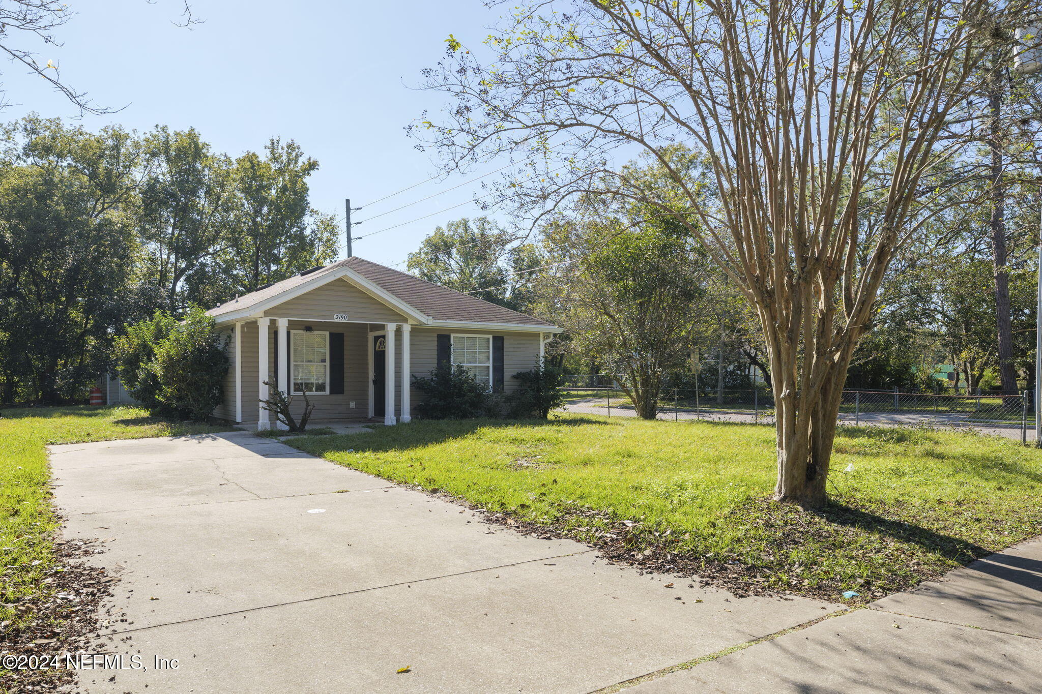 a front view of a house with yard and tree s