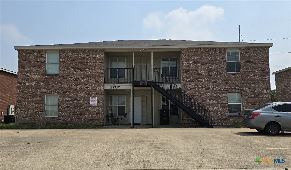 a front view of a house with parking space