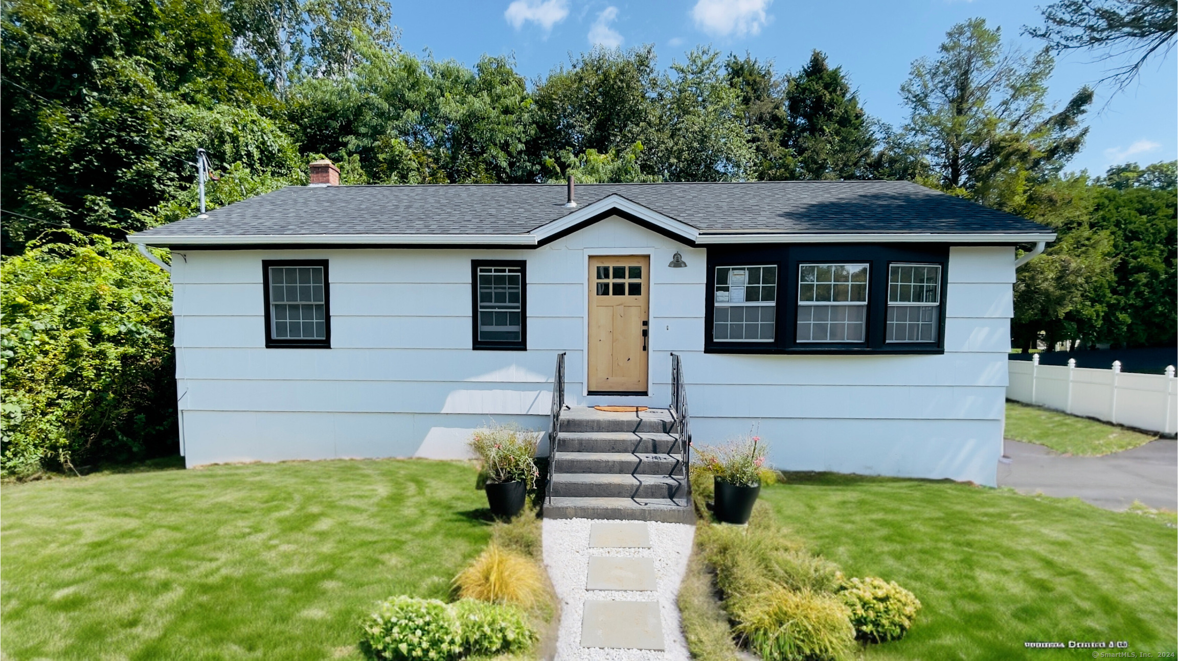 a front view of a house with garden