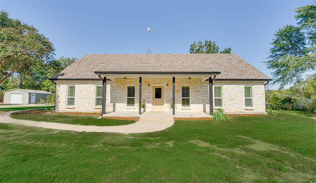 a front view of a house with a garden and porch