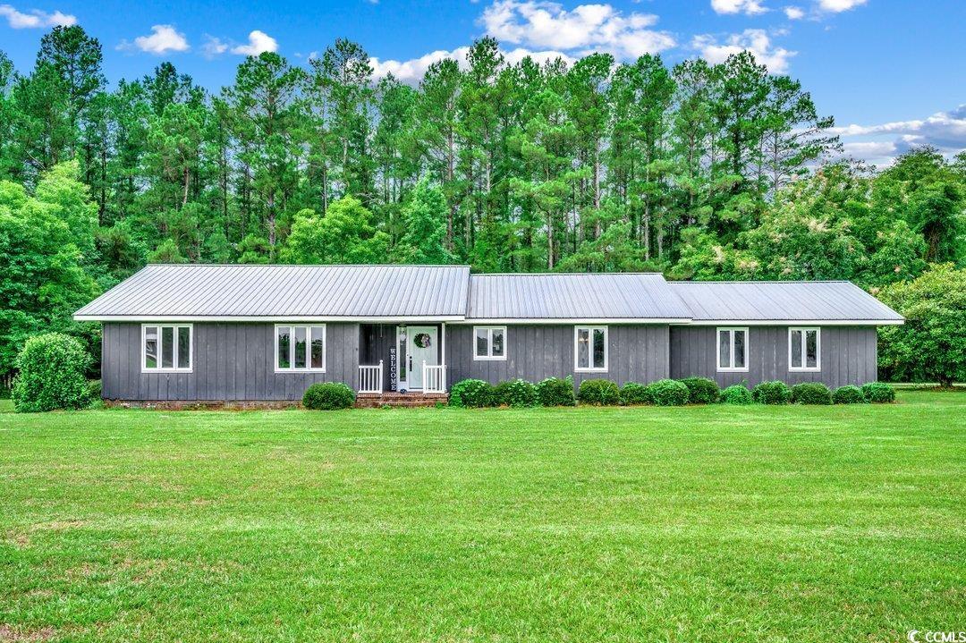 Single story home with a front lawn