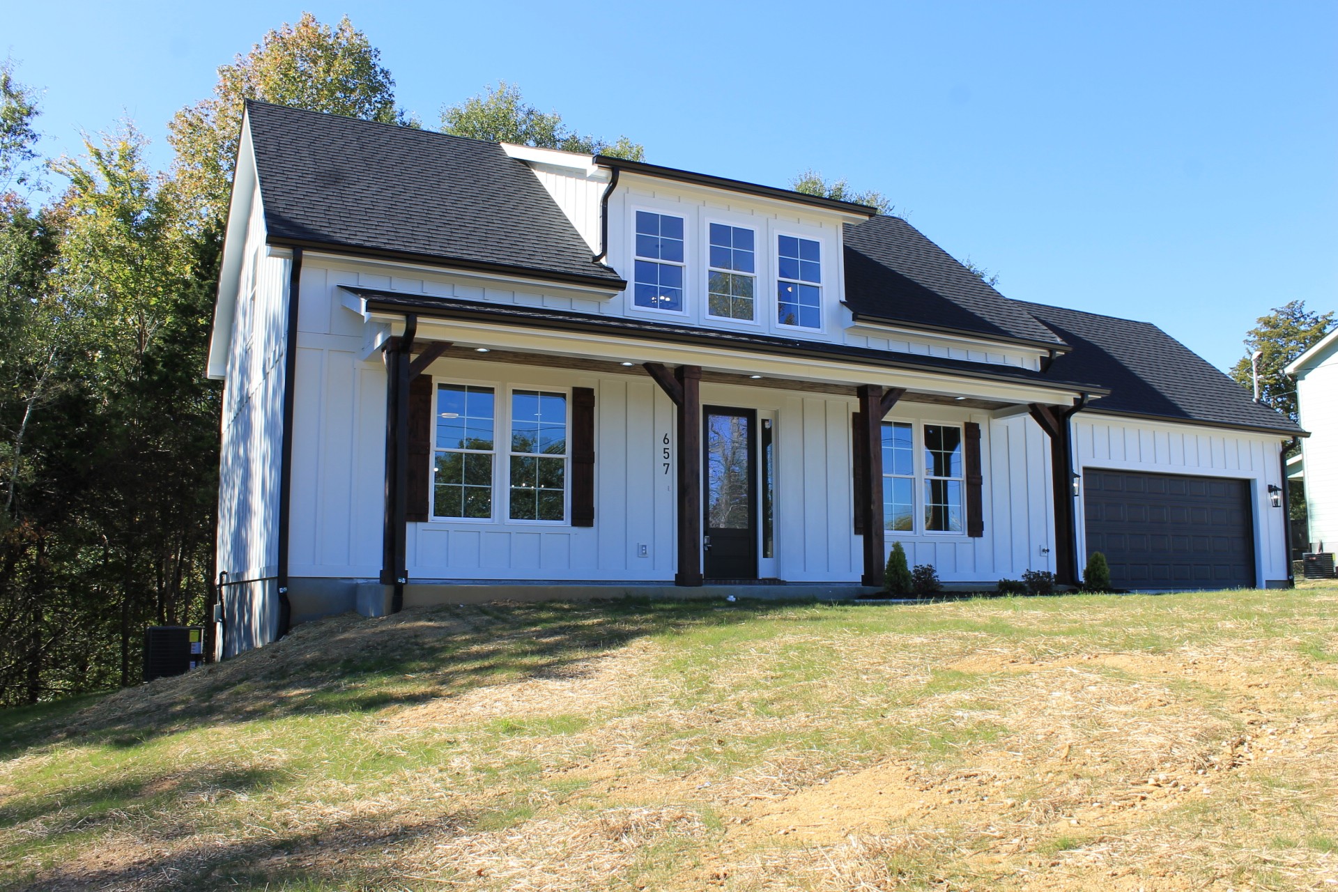 a front view of brick house with a yard