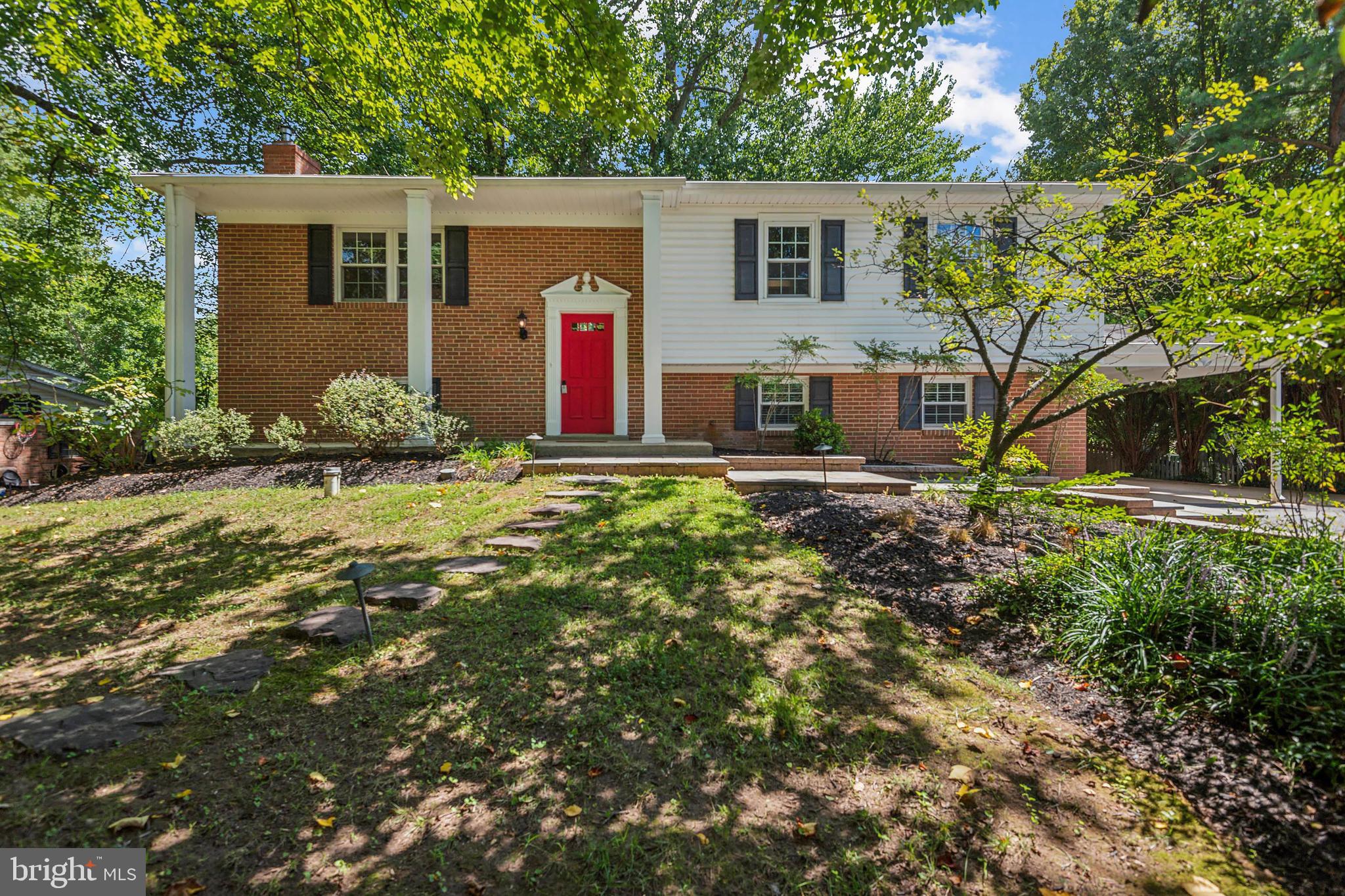 a front view of house with yard and trees