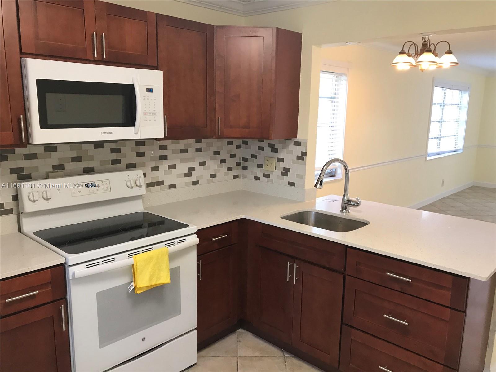 a kitchen with a sink and a stove top oven